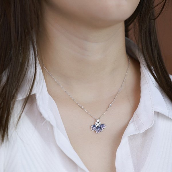 Flower Necklace worn at the collarbone by woman in white shirt