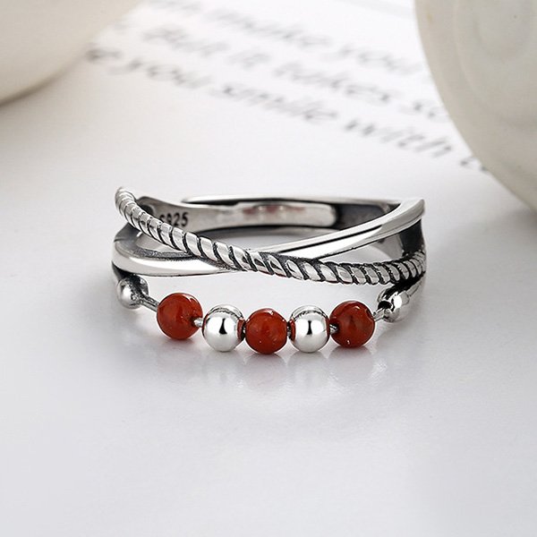 Sterling Silver Ring worn on finger over open book in vintage style