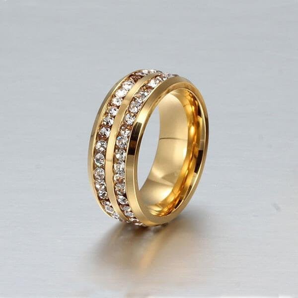 Eternity Band Italo titanium steel yellow gold with channel-set white sapphires angled studio shot