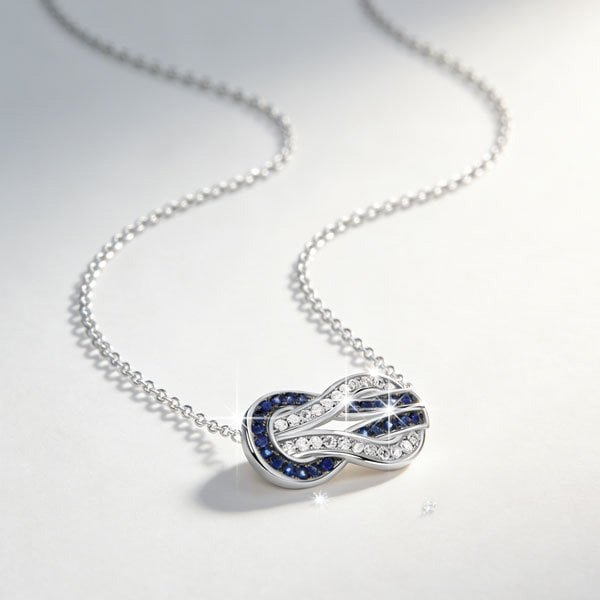 Pendant Necklace Italo infinity blue and white sapphire close-up with sparkle on soft background